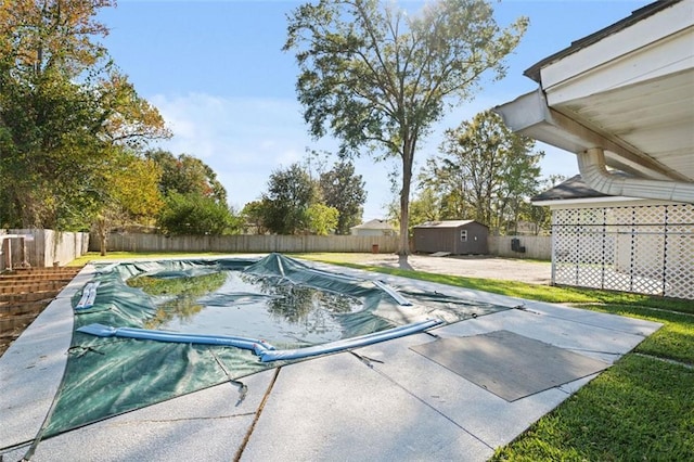 view of pool featuring a storage unit and a patio area