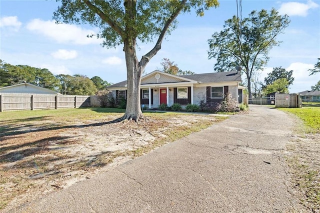 ranch-style home with a front lawn