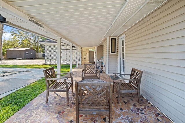 view of patio / terrace with a shed