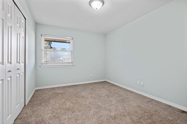 unfurnished bedroom featuring carpet flooring and a closet