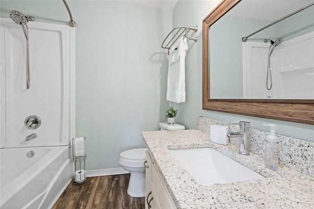 full bathroom featuring shower / bathing tub combination, wood-type flooring, vanity, and toilet