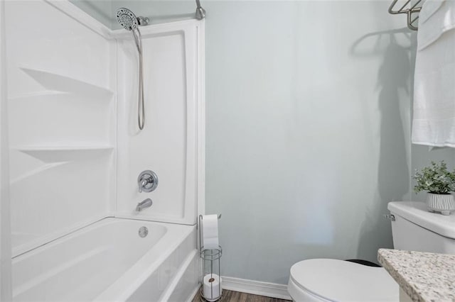 full bathroom featuring vanity, wood-type flooring, bathtub / shower combination, and toilet