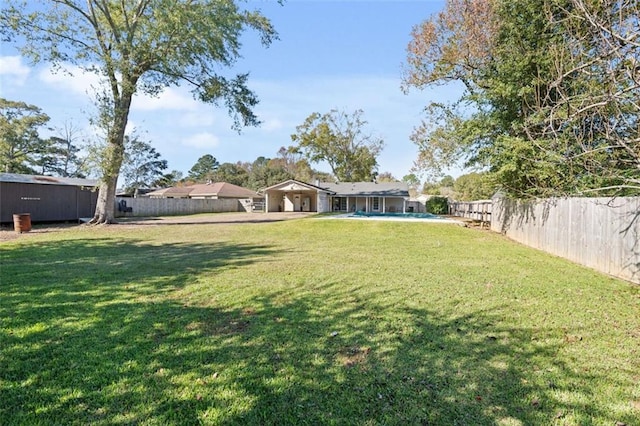 view of yard with a fenced in pool