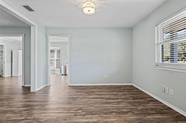 spare room with dark hardwood / wood-style flooring