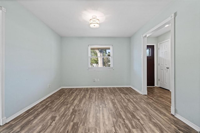 unfurnished room featuring dark hardwood / wood-style floors