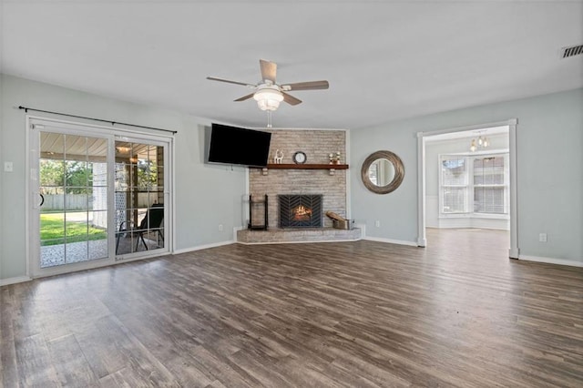 unfurnished living room featuring dark hardwood / wood-style floors, ceiling fan, and a fireplace