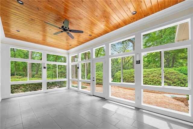 unfurnished sunroom featuring wood ceiling and ceiling fan