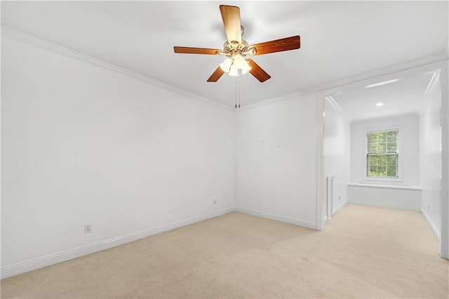 carpeted empty room with ceiling fan and crown molding