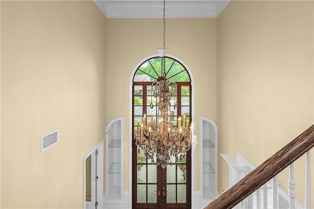 interior details with a chandelier and french doors