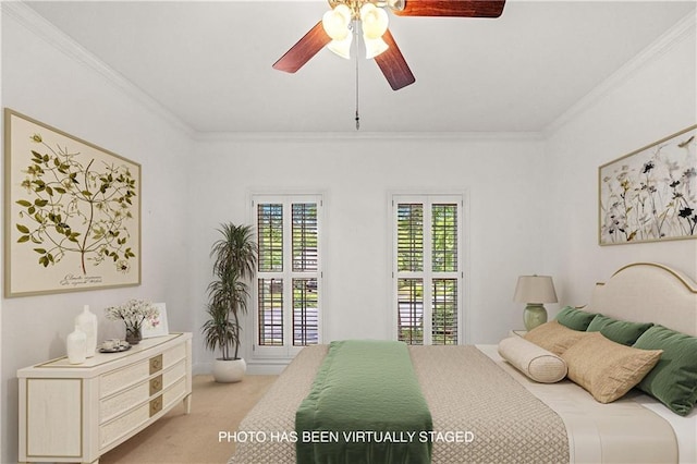 carpeted bedroom featuring ceiling fan and crown molding