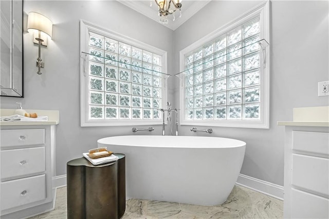 bathroom featuring vanity, a washtub, and a notable chandelier