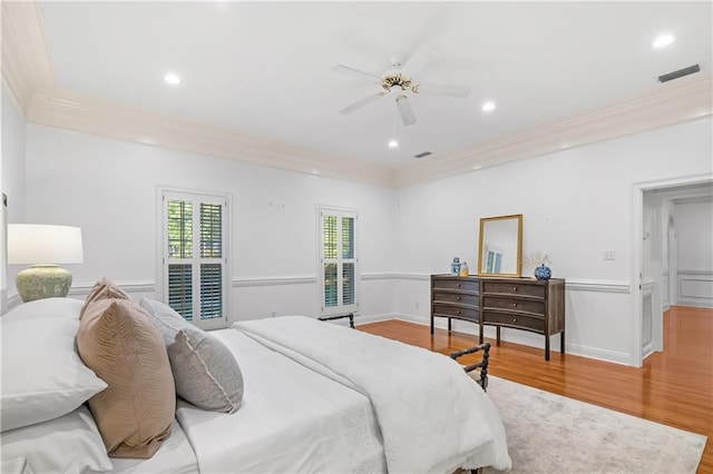 bedroom featuring wood-type flooring, ceiling fan, and crown molding