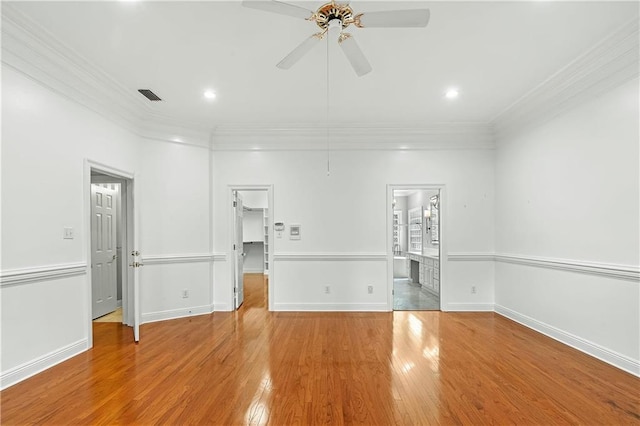 empty room featuring ceiling fan, light hardwood / wood-style floors, and ornamental molding