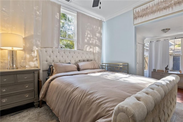 bedroom with ceiling fan and ornamental molding