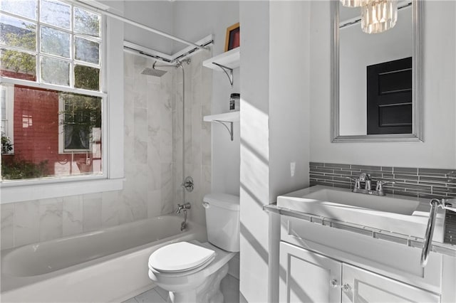 full bathroom featuring backsplash, vanity, toilet, and tiled shower / bath