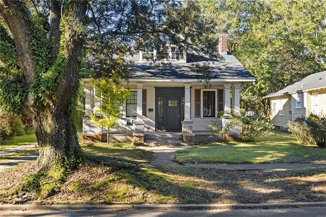 view of front facade with covered porch and a front yard