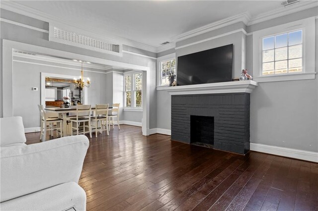 living room featuring a fireplace, wood-type flooring, and ornamental molding