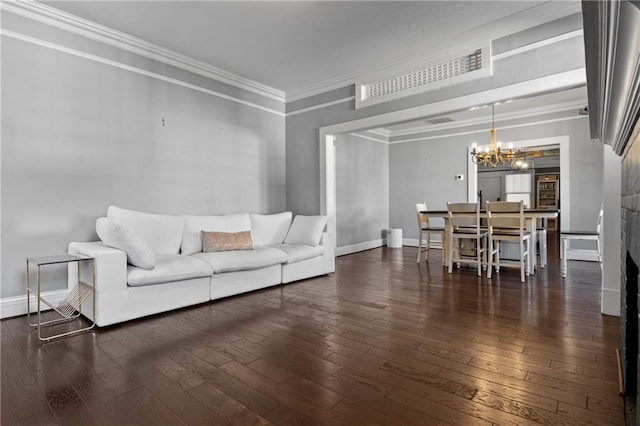 living room featuring a chandelier, dark hardwood / wood-style floors, and ornamental molding