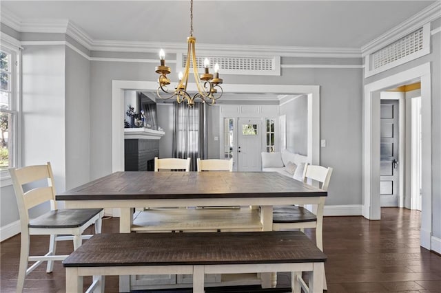 dining area with a notable chandelier, dark hardwood / wood-style flooring, and crown molding