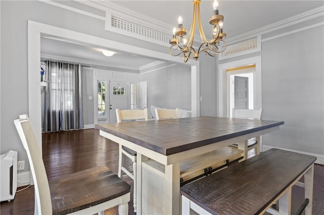 unfurnished dining area with a notable chandelier, dark hardwood / wood-style floors, and ornamental molding