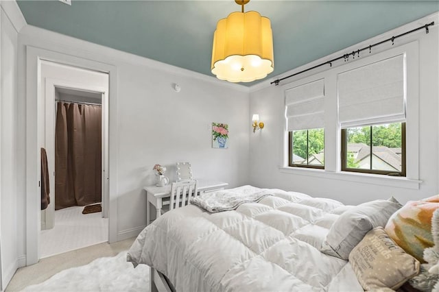 bedroom with light colored carpet and baseboards