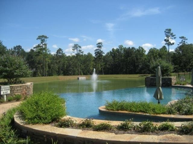 view of community with a water view