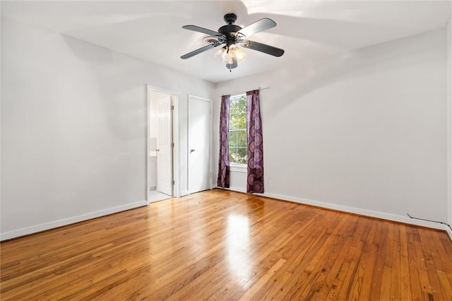 empty room with ceiling fan and light hardwood / wood-style floors