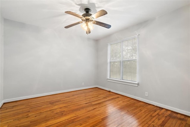 spare room with light wood-type flooring and ceiling fan