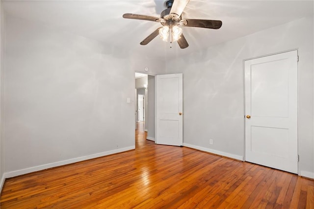 empty room with ceiling fan and wood-type flooring