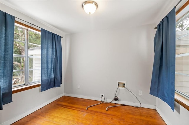 unfurnished room with plenty of natural light and wood-type flooring