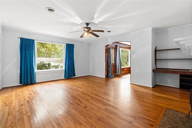 interior space featuring ceiling fan, crown molding, and light wood-type flooring