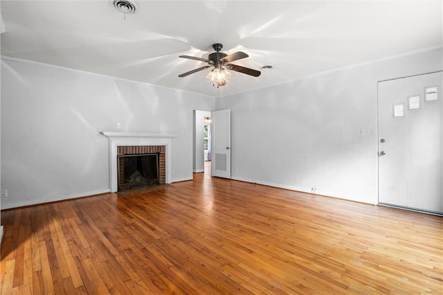 unfurnished living room with a fireplace, light hardwood / wood-style floors, and ceiling fan