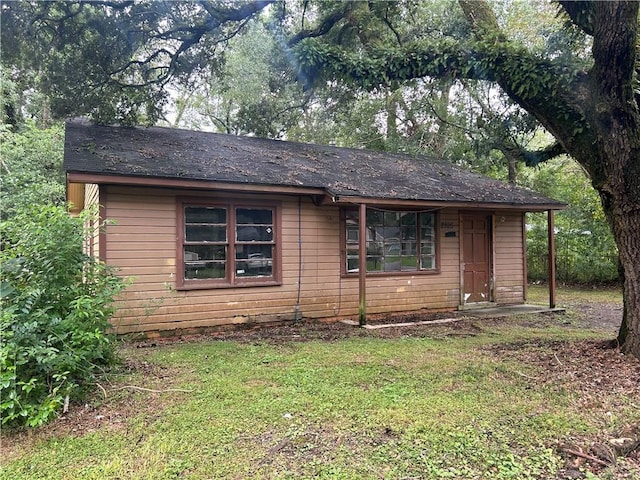 view of home's exterior with a yard