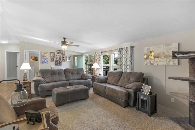 living area with carpet flooring, ceiling fan, and lofted ceiling