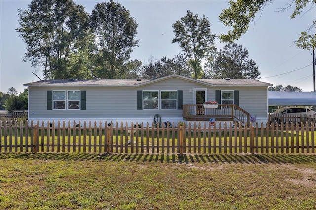manufactured / mobile home featuring a fenced backyard, a front lawn, and a deck