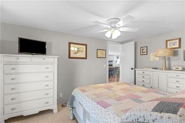 bedroom with a ceiling fan and light carpet