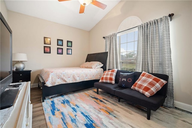 bedroom with lofted ceiling, hardwood / wood-style floors, and ceiling fan