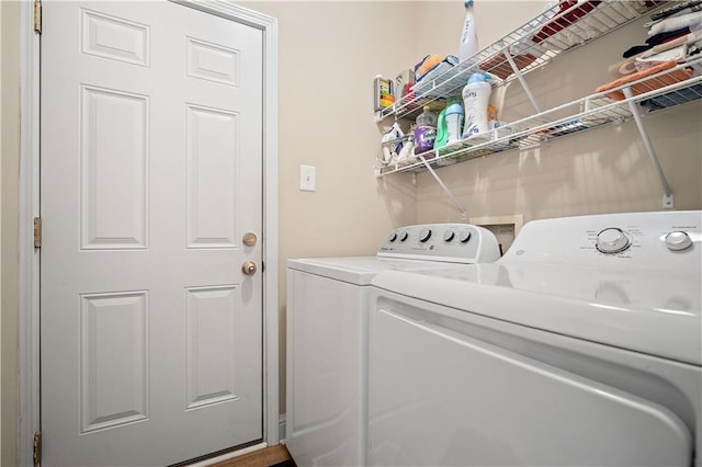 clothes washing area with washer and clothes dryer