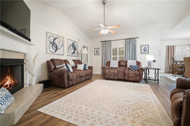 living room featuring plenty of natural light, dark wood-type flooring, and a tile fireplace