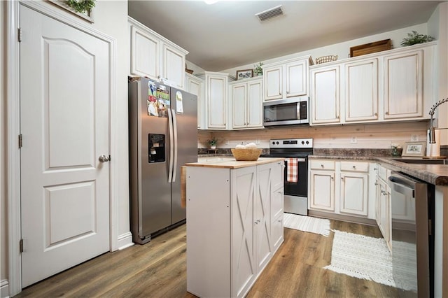 kitchen featuring white cabinets, stainless steel appliances, sink, and dark hardwood / wood-style flooring