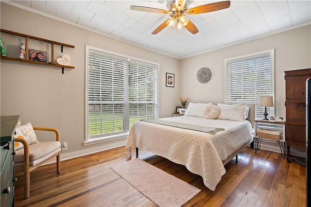 19565 4th St N, Citronelle, AL 36522 - bedroom featuring crown molding, multiple windows, wood-type flooring, ceiling fan, and baseboards