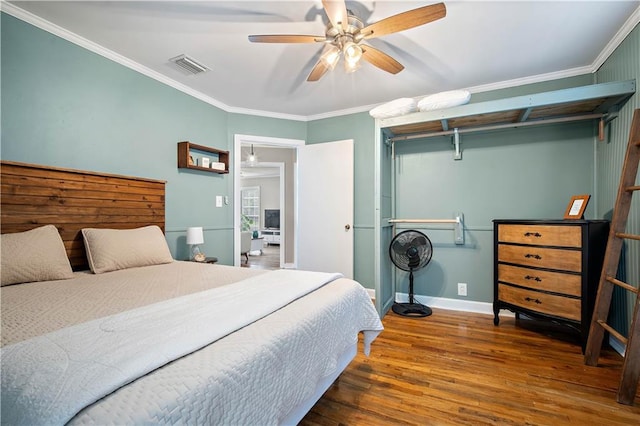 19565 4th St N, Citronelle, AL 36522 - bedroom featuring wood finished floors, baseboards, ornamental molding, and a ceiling fan