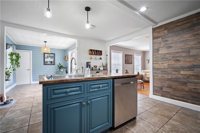 19565 4th St N, Citronelle, AL 36522 - kitchen with stainless steel dishwasher, blue cabinets, wood walls, a center island with sink, and a sink