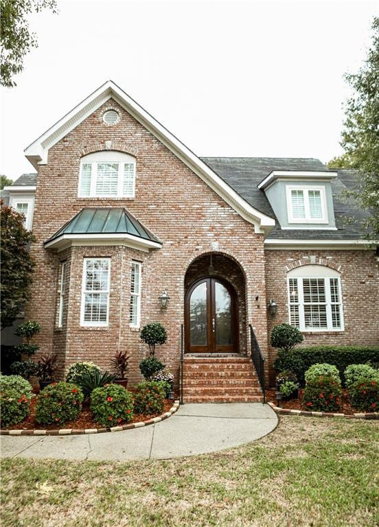 view of front facade featuring a front lawn and french doors