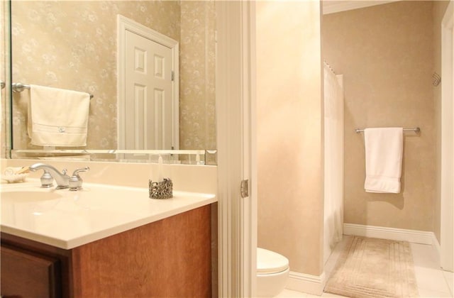 bathroom with tile patterned flooring, vanity, and toilet