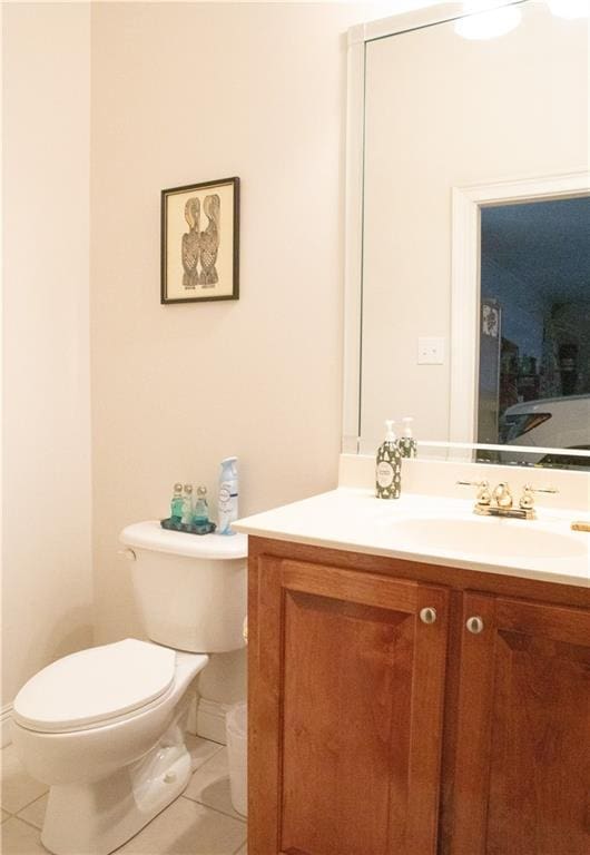 bathroom featuring tile patterned flooring, vanity, and toilet