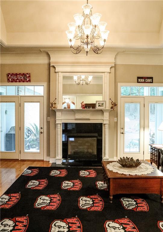 living room with hardwood / wood-style floors and an inviting chandelier