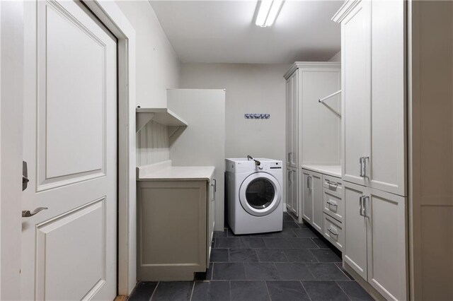 1660 Laurel St, Mobile, AL 36604 - washroom featuring washer / dryer, cabinet space, and dark tile patterned floors