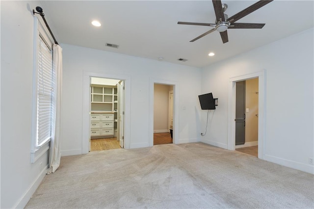 1660 Laurel St, Mobile, AL 36604 - unfurnished bedroom featuring light colored carpet, a walk in closet, recessed lighting, and baseboards
