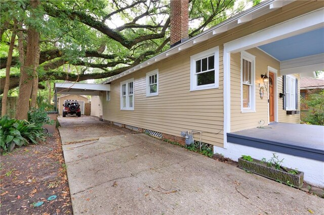 1660 Laurel St, Mobile, AL 36604 - view of property exterior featuring driveway, a chimney, and an attached carport